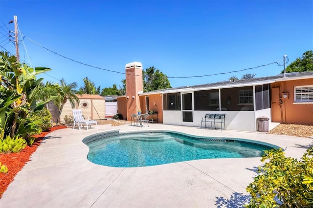 view of swimming pool featuring a sunroom, a fenced in pool, fence, and a patio area
