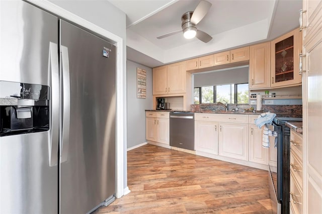 6263 Midnight Pass Rd Unit 301, Sarasota, FL 34242 - kitchen featuring stainless steel appliances, a tray ceiling, light wood-style flooring, glass insert cabinets, and ceiling fan