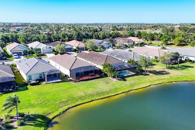 drone / aerial view with a residential view and a water view