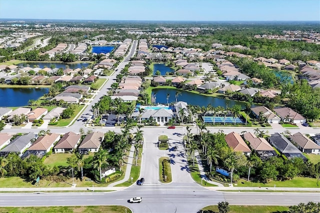 drone / aerial view featuring a water view and a residential view