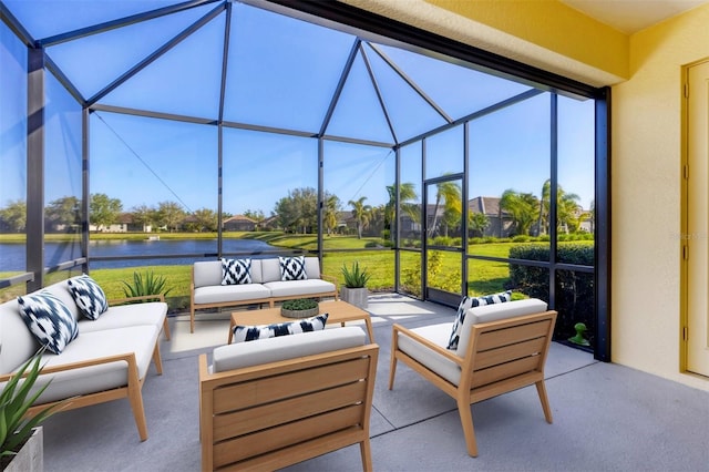 view of patio featuring glass enclosure, a water view, and outdoor lounge area