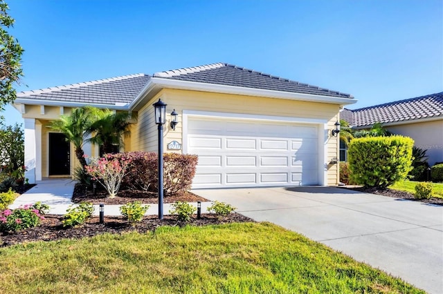 ranch-style house with a garage, driveway, and a tile roof