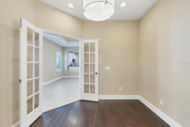 spare room with recessed lighting, baseboards, dark wood finished floors, and french doors