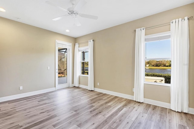 unfurnished room featuring recessed lighting, baseboards, and light wood-style flooring