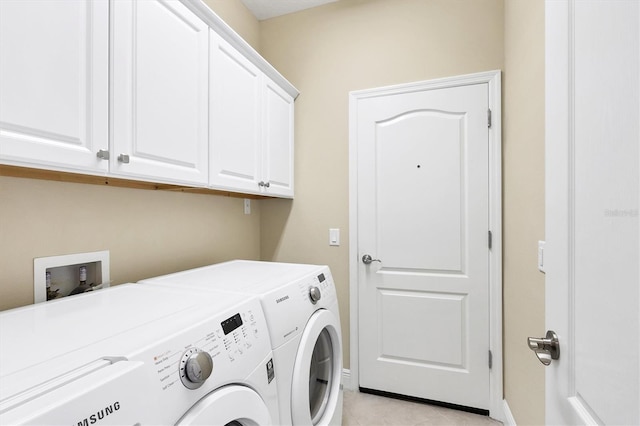 laundry area featuring cabinet space, light tile patterned flooring, baseboards, and washing machine and dryer