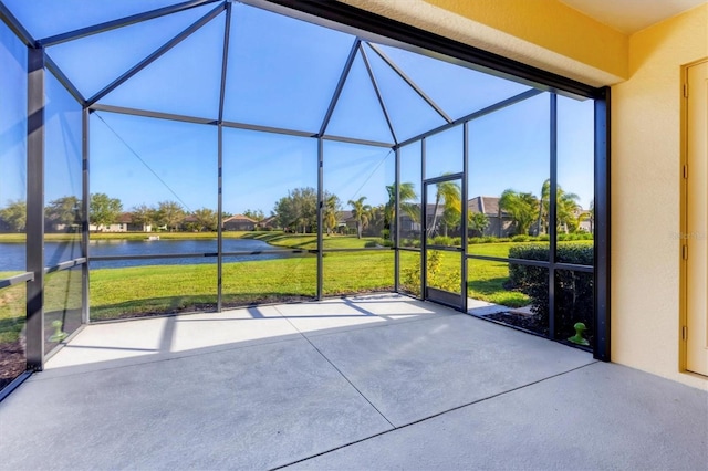 unfurnished sunroom with a residential view and a water view
