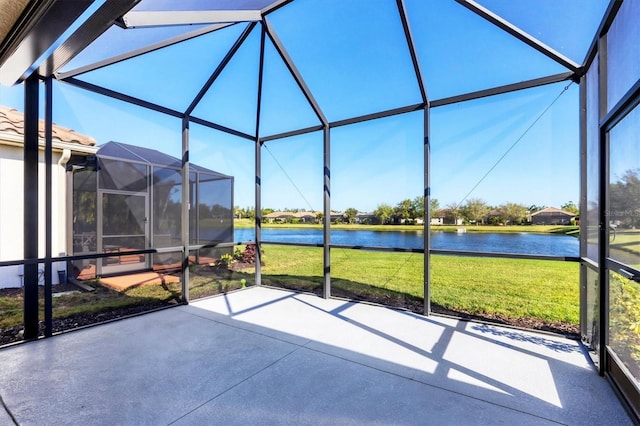 sunroom / solarium featuring a water view