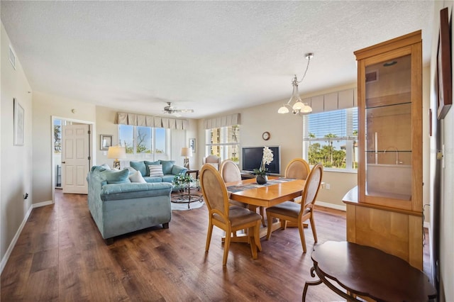 dining area with a wealth of natural light, visible vents, dark wood-type flooring, and a textured ceiling