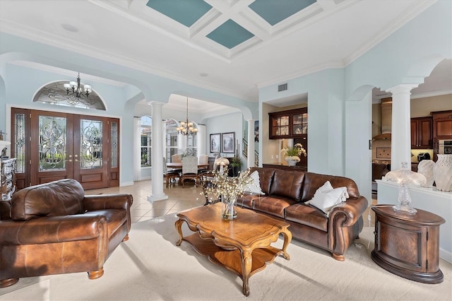 living area featuring a chandelier, arched walkways, light tile patterned floors, and decorative columns