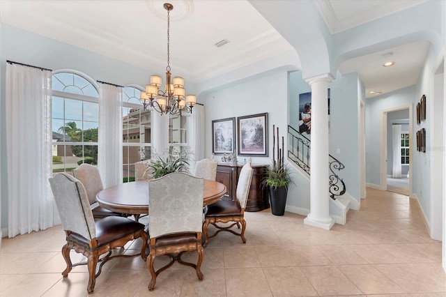 dining space with ornate columns, a notable chandelier, baseboards, and stairs