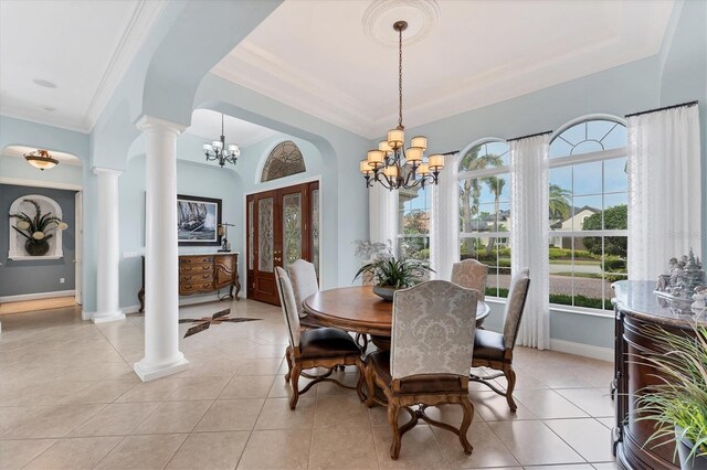 dining area with a notable chandelier, ornate columns, ornamental molding, and light tile patterned flooring