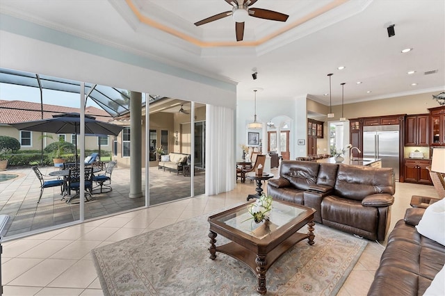 living area with a healthy amount of sunlight, light tile patterned flooring, and a ceiling fan