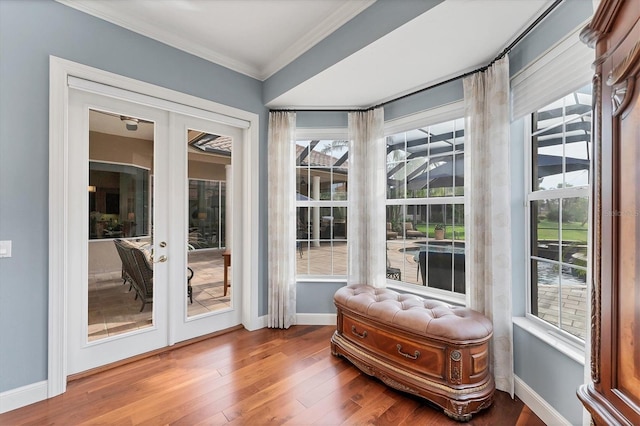 entryway featuring french doors, baseboards, ornamental molding, and wood finished floors