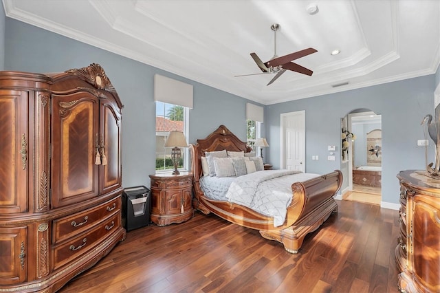 bedroom with arched walkways, dark wood-style floors, crown molding, and ensuite bathroom