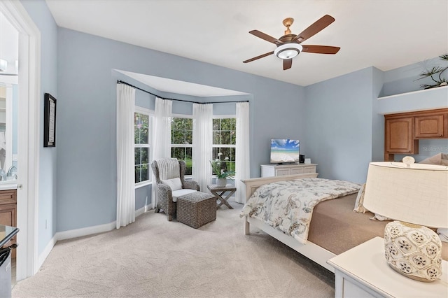 bedroom featuring baseboards, a ceiling fan, and light colored carpet