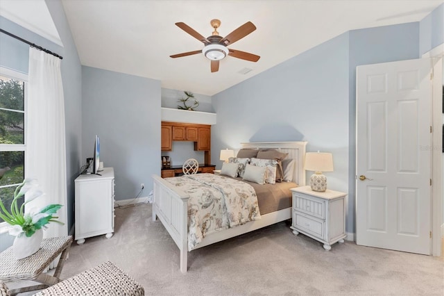 bedroom featuring light carpet, ceiling fan, and baseboards
