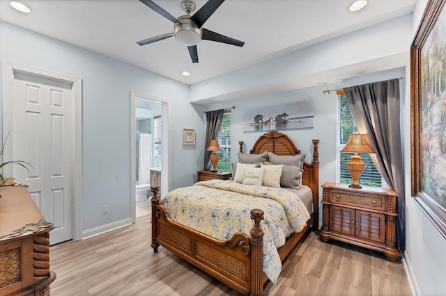 bedroom featuring recessed lighting, light wood-style floors, baseboards, and connected bathroom