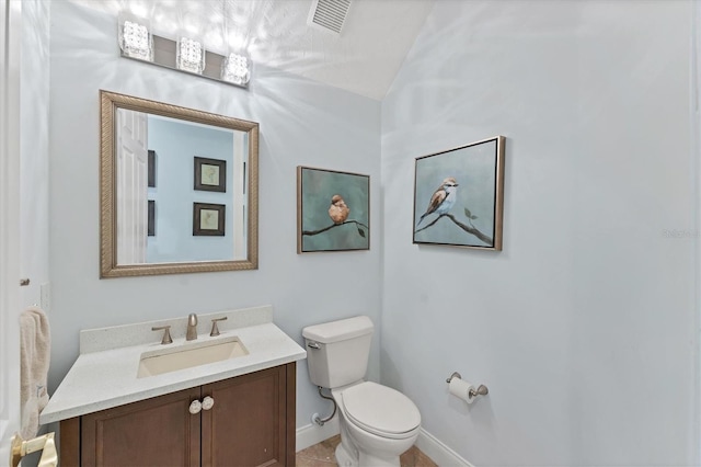 half bath featuring toilet, vanity, and baseboards