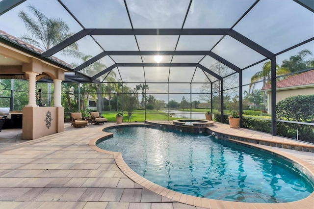 view of swimming pool with a patio area, a pool with connected hot tub, and glass enclosure