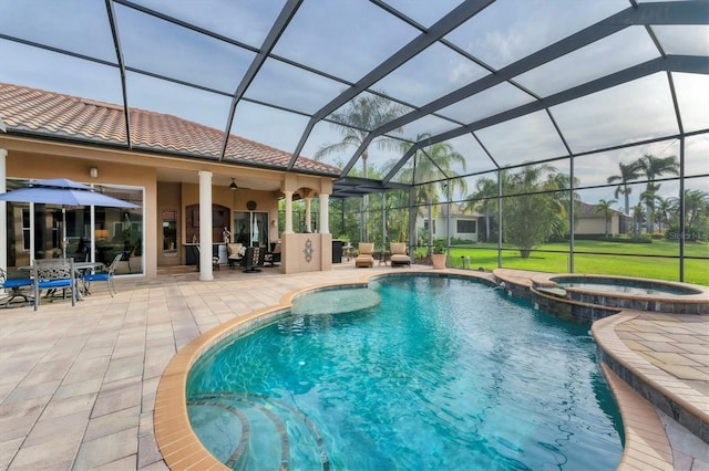 view of pool with a patio area, a pool with connected hot tub, and glass enclosure
