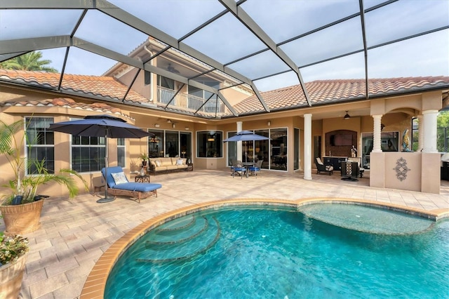 outdoor pool featuring a patio, a lanai, a ceiling fan, and an outdoor hangout area