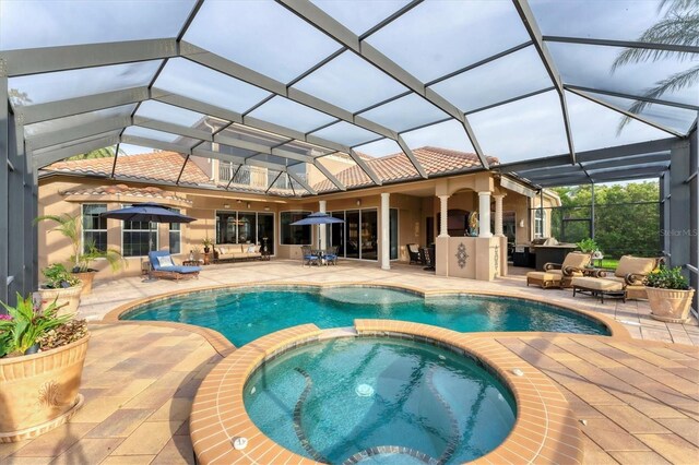 view of pool with an outdoor living space, a patio, a pool with connected hot tub, and glass enclosure