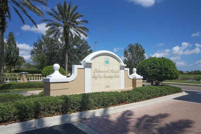 community / neighborhood sign with a water view
