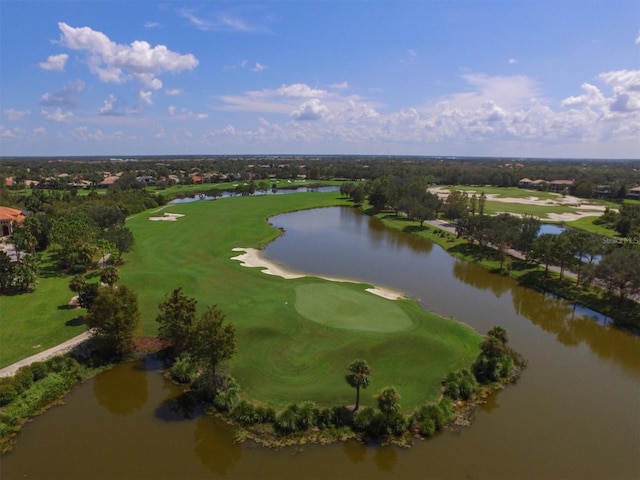 drone / aerial view featuring view of golf course and a water view