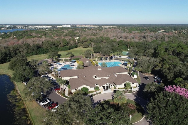 birds eye view of property featuring a wooded view