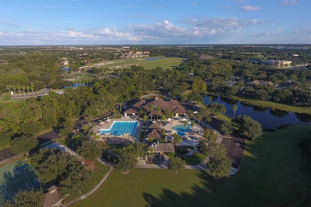drone / aerial view with a view of trees and a water view