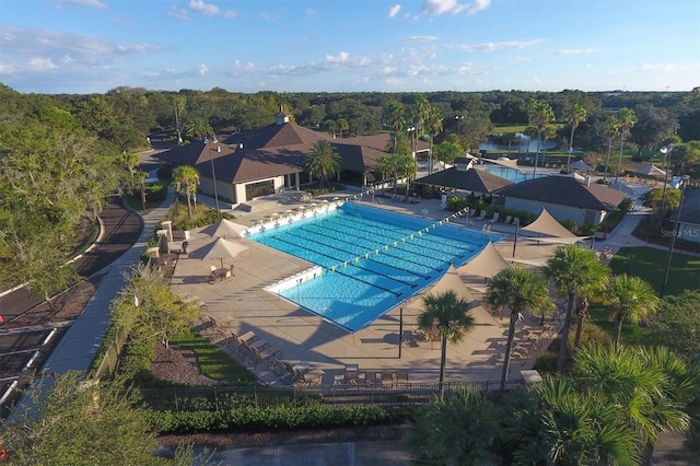 community pool featuring a patio area and fence