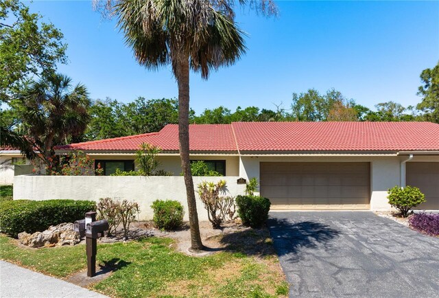 3804 Sun Eagle Ln, Bradenton, FL 34210 - ranch-style house with stucco siding, aphalt driveway, fence, and a tiled roof