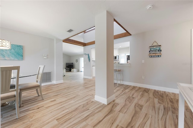 3804 Sun Eagle Ln, Bradenton, FL 34210 - dining room with baseboards, lofted ceiling, light wood-style flooring, and visible vents