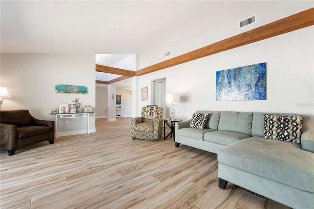 3804 Sun Eagle Ln, Bradenton, FL 34210 - living area featuring visible vents, baseboards, vaulted ceiling, and light wood-type flooring