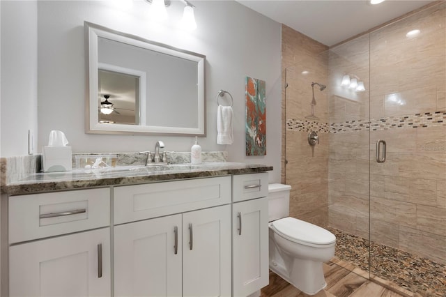 3804 Sun Eagle Ln, Bradenton, FL 34210 - full bathroom with vanity, a ceiling fan, toilet, and a shower stall
