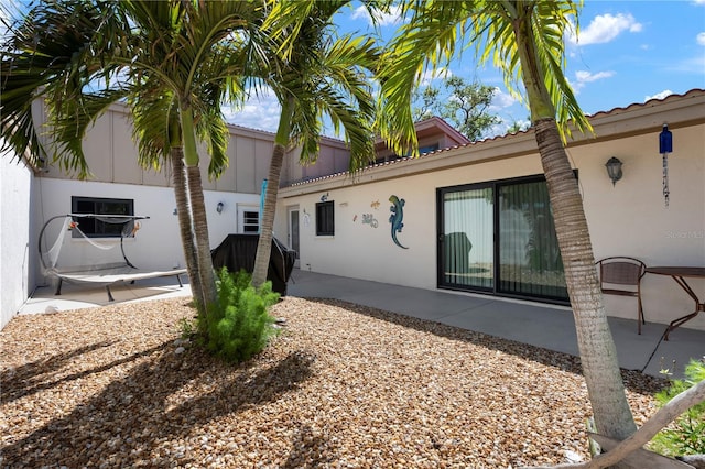 3804 Sun Eagle Ln, Bradenton, FL 34210 - rear view of property featuring stucco siding, a tile roof, and a patio area