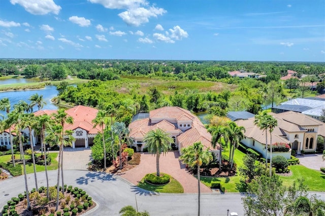 drone / aerial view featuring a water view and a residential view