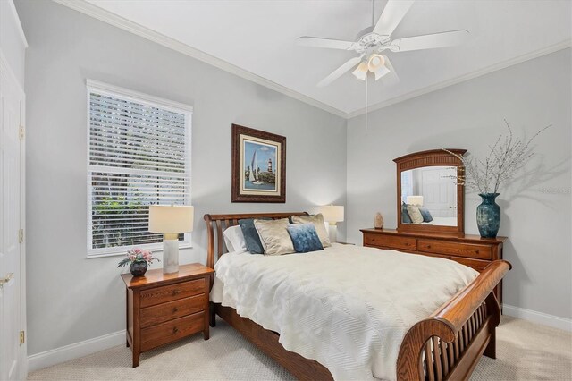 bedroom with crown molding, baseboards, a ceiling fan, and light colored carpet