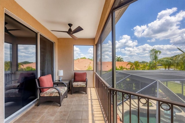 sunroom with a ceiling fan and a wealth of natural light