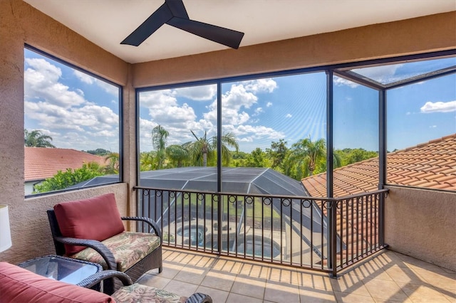 sunroom / solarium featuring a wealth of natural light and ceiling fan