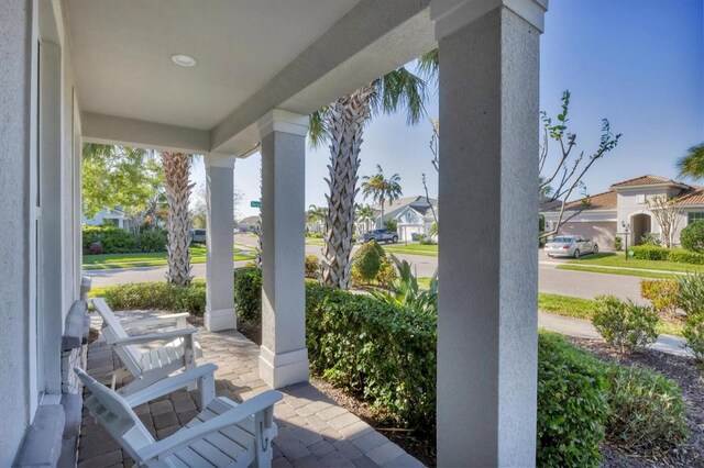 11717 Blue Hill Trl, Lakewood Ranch, FL 34211 - view of patio with a residential view and a porch