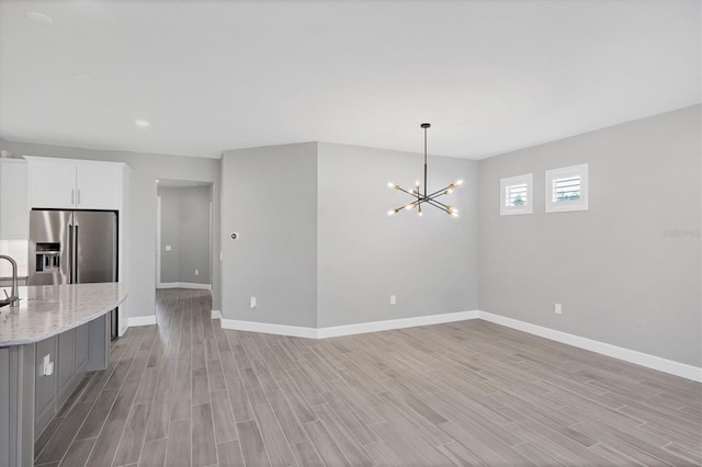 11717 Blue Hill Trl, Lakewood Ranch, FL 34211 - interior space featuring an inviting chandelier, light wood-style floors, and baseboards