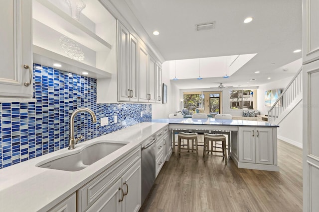 1928 Harbourside Dr Unit 1403, Longboat Key, FL 34228 - kitchen with a sink, open floor plan, wood finished floors, tasteful backsplash, and recessed lighting
