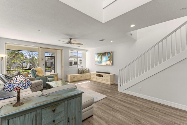 1928 Harbourside Dr Unit 1403, Longboat Key, FL 34228 - living area featuring baseboards, a ceiling fan, wood finished floors, stairs, and recessed lighting