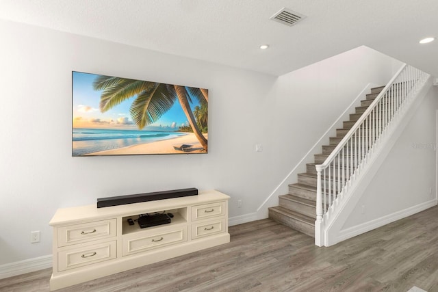 1928 Harbourside Dr Unit 1403, Longboat Key, FL 34228 - staircase with baseboards, wood finished floors, and recessed lighting