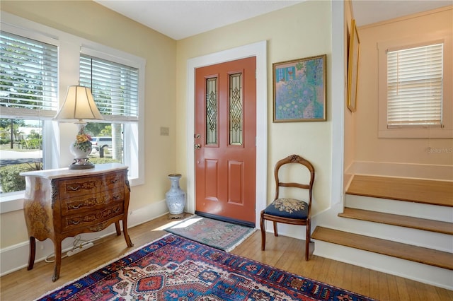 entrance foyer featuring stairs and wood finished floors