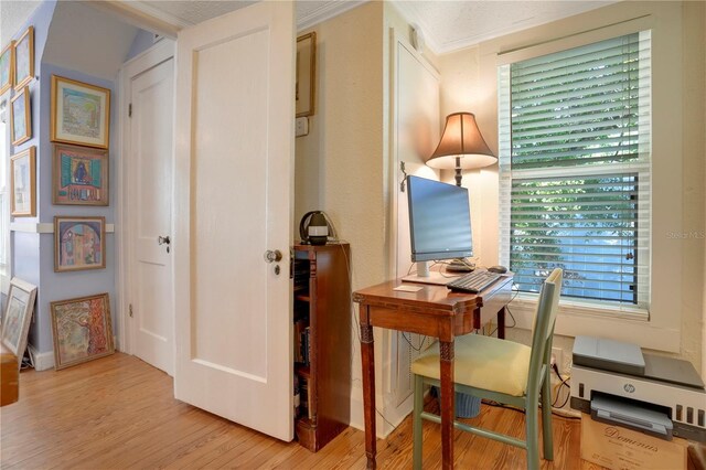 office area with crown molding and wood finished floors
