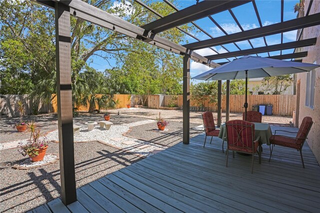 deck featuring a pergola and a fenced backyard