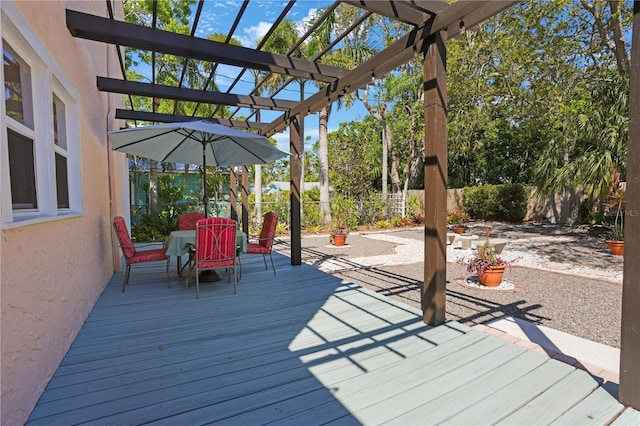 wooden terrace featuring outdoor dining space, a pergola, and fence