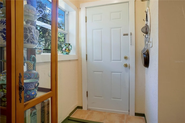 entryway with tile patterned floors and baseboards